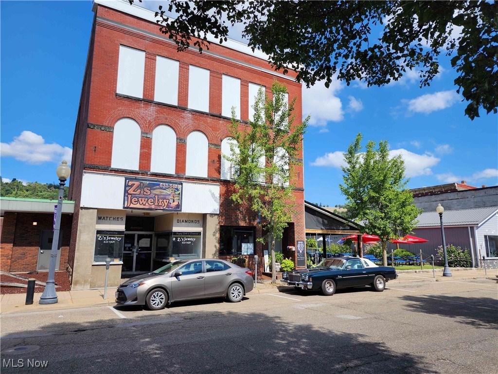 This three-story commercial building offers excellent visibility and versatile potential. The ground floor features two storefronts, one restaurant with lease. Above, the second and third floors present a significant redevelopment opportunity with space for multiple apartment units. While the upper floors require extensive renovation, the structure and layout offer a strong foundation for revitalization. Positioned in a central downtown location with convenient access to major routes, this property is well-suited for investors or owner-occupants looking to restore and reimagine a mixed-use building.
