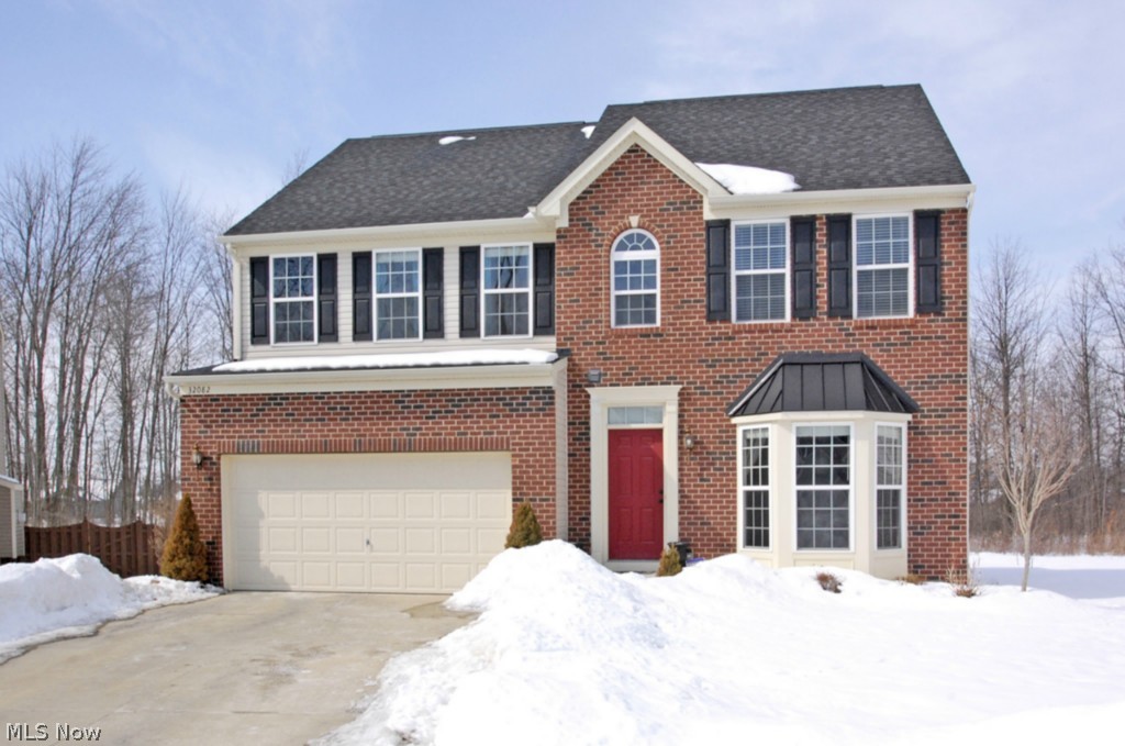 Remarkable opportunity to live in prestigious Timber Ridge, one of North Ridgeville's most sought after communities! Located on a prime cul-de-sac street, this home has many high end options including full brick front and upgraded, wooded home-site complete with pond views. The moment you step through the front door you will be wowed by the gleaming natural cherry hardwood flooring. Highly desirable two story great-room will excite even the most discerning of buyers, two story wall of windows gives ample sunlight to create the ultimate living environment. Relax in front of the two story - stone faced gas fireplace. Wonderfully upgraded kitchen will bring out the chef in you. It features maple cabinetry, custom stone back-splash and all newer appliances. Kitchen is open to the expansive, morning room which overlooks the custom, stamped concrete outdoor patio with amazing views over the picturesque pond off your back yard. Home even features unbelievable finished basement, basement was