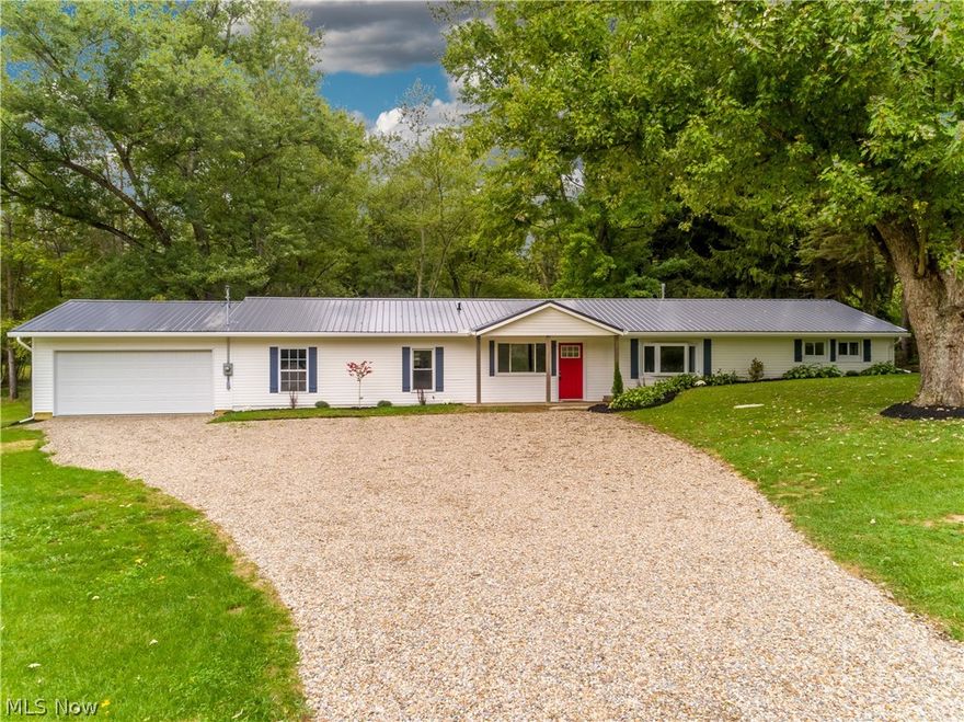 WOW! Completely renovated ranch in Manchester LSD! This beautiful home has an open floor plan, with over 1,800 square feet of living space all on one floor! Four bedrooms, including a generously sized master bedroom and bathroom with dual vanities, granite countertops, all tile shower, and even a bluetooth enabled bathroom fan! Modern plank flooring runs throughout the majority of the home. You'll love the updated kitchen with soft close cabinetry, modern tile backsplash, granite countertops, plus new stainless steel appliances! Enjoy the Fall weather in the sun room or on the concrete patio, both overlooking the gorgeous backyard. Sitting on over 2 acres, the property is secluded with a fire pit, mature trees, and 2 storage barns. 2 car attached garage. New fixtures, flooring, fresh paint, and windows run throughout the entire home. Other 2018 updates include: Well pump, hot water tank, metal roof, electric panel and wiring throughout, water softener, gutters and downspouts, plus bran