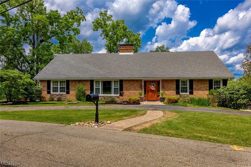 Welcome to this spacious, 4 bedrooms, 3.5 bath, custom built all brick home located just outside of St. Clairsville city limits on 4.9 acres. As you step inside, you will be greeted by the foyer and an open-concept of the formal living room and dining room.  The kitchen boasts of beautiful cabinetry, granite countertops, and stainless steel appliances.  Laundry room conveniently located off the kitchen as well as a half bath.  Three additional bedrooms with spacious closets, full bath, and sitting room completes the upstairs.  The finished lower level consist of a spacious rec room, full bath, and plenty of places for storage.  What's great about this property you can entertain inside or outside.  The backyard is surrounded by nature's splendor, paver patio with fire pit and inground pool making outdoor entertainment and relaxation a joy.  The 40X30 barn comes complete with concrete and electric.  There is also a half basketball court off the barn.  What a uniquely amazing place to call home!  1 year home warranty included.