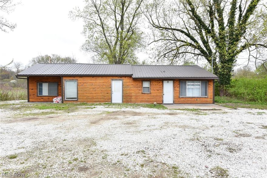 A variety of options for potential buyer! This log cabin ranch is zoned C-1 commercial and can also be used as multi-family by closing off one wall or a single family home. Located near a multitude of commercial business with a traffic count of over 10,000 cars per day. 100 feet of street frontage on .63 acres. Public sewer. Completely renovated within the last five years inside and out. First floor living or working environment. Recent updates include central air, high efficient furnace, metal roof with seamless spouting, cedar log siding, new double pane windows, all new plumbing, LED lighting, remodeled bathrooms, hot water tank and water softener. Each unit has two bedrooms and a full bath with eat-in kitchens. South unit has large living room with wood burning fireplace. All rooms could be separate office spaces. Includes two stoves, one microwave and one refrigerator. First floor laundry hook up. Potential commercial uses could be bank, restaraunt, dry cleaners, beauty massage, dog kennel, farmers market, retail, day care, office space, light commercial, single family residential, single family with inlaw suite or multi-family. Check with Lake Township Zoning for full list and see if this is the space for all your entrepreneurial dreams!