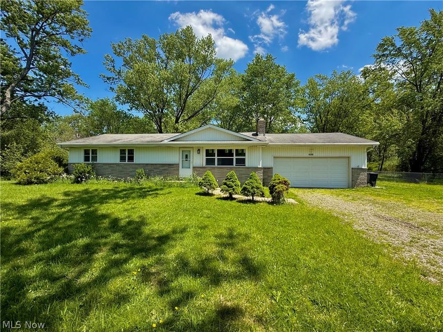 Welcome to 4088 Lynwood Drive -- a spacious ranch tucked away on a dead-end street in Brimfield Township within Field LSD. Offering 4 bedrooms, 1.5 baths, 1,196 sqft and just shy of 1 acre on a double lot, this home combines updates with the opportunity to add your own finishing touches over time. Inside, you'll find an inviting layout with updated LVP flooring, carpeting, newer windows, fixtures, exterior doors, laminate counter tops, modern cabinetry, ample counter space, and an open flow into the dining area. The primary bedroom includes its own private half bath, while the updated full bath adds a fresh, modern feel. The attached oversized 2-car garage offers excellent storage and workspace potential, while the full basement provides additional room for recreation, hobbies, entertaining, or future finishing. Outside, enjoy the fully fenced backyard and peaceful setting with mature trees surrounding the property. Major improvements include an aeration septic system, A/C unit, and newer water softener system for added peace of mind. This home is ready for someone to come in and make it their very own. Conveniently located near shopping, dining, parks, and highway access while still offering privacy and space of township living on .92 acres.