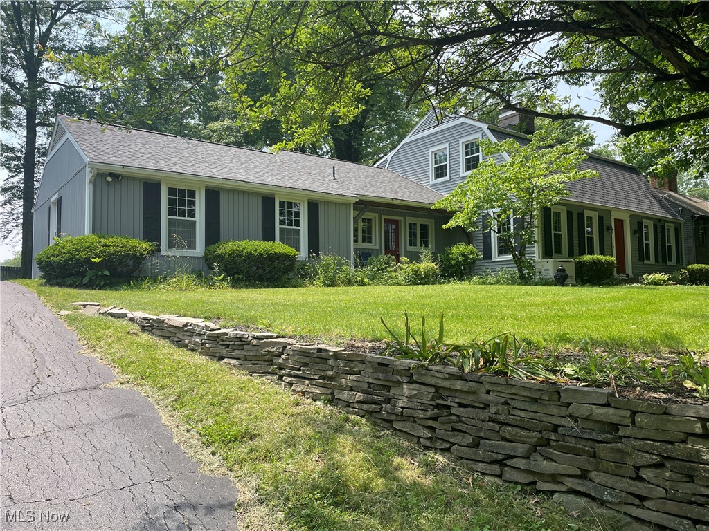 4 Bedroom, 3 Bath, 2258 SF Williamsburg Style Colonial in Canfield, OH. Raised lot on hill with large pond with fountain in front. Lower parking area and attached two car rear facing garage on beautiful wooded lot. Home features large first floor master bedroom addition, with full bath. Spacious 3 season room. Formal living room with Williamsburg style fireplace. Family room with fireplace. Formal dining room. Large eat in kitchen. Three large bedrooms on second floor with full bath. Extra storage above garage. Whole house fan. Full basement divided into laundry and rec. area with a third full bath. Appliances stay. Newer 95 efficiency furnace and HVAC. Recently installed whole house generator. Newer roof. Plank hardwood flooring in may areas, newer windows. This home has been exceptionally well cared for by long term owner. Move in condition with a few updates to kitchen. Exceptional Canfield location/Canfield schools. Surrounded by other custom homes. Call any real estate agent for a private showing.