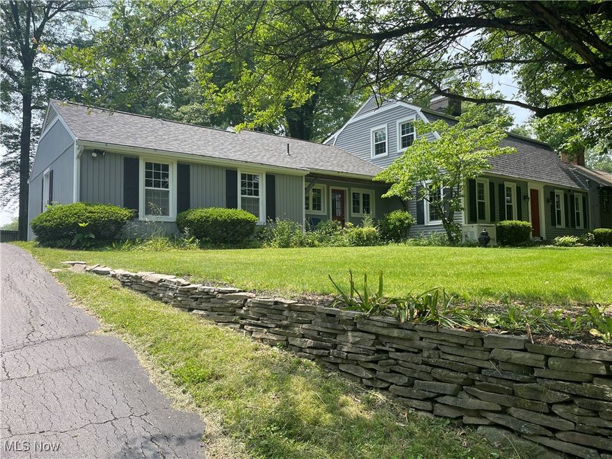 Recently Reduced.  Exceptional Value, Canfield Schools.  4 Bedroom, 3 Bath, 2258 SF Williamsburg Style Colonial in Canfield, OH.  Raised lot on hill with large pond with fountain in front.  Lower parking area and attached two car rear facing garage on beautiful wooded lot.  Home features large first floor master bedroom addition, with full bath.  Spacious 3 season room.  Formal living room with Williamsburg style fireplace.  Family room with fireplace.  Formal dining room. Large eat in kitchen.  Three large bedrooms on second floor with full bath. Extra storage above garage. Whole house fan.  Full basement divided into laundry and rec. area with a third full bath. Appliances stay.  Newer 95 efficiency furnace and HVAC.  Recently installed whole house generator.  Newer roof. Plank hardwood flooring in may areas, newer windows.  This home has been exceptionally well cared for by long term owner.  Move in condition with a few updates to kitchen. Exceptional Canfield location/Canfield schools.  Surrounded by other custom homes. Call any real estate agent for a private showing.