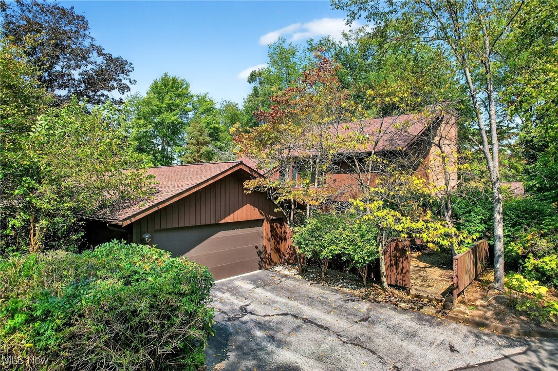 Indulge in the tranquil, wooded setting of 1939 Pine Drive: a 3BR, 2.5BA property with 2 car attached garage, vaulted ceilings, skylights, 2 WBFPs, balcony & patio areas, and abundant storage at every turn! Complete with a private courtyard entry with endless potential for your personal retreat, the double doors of this 1971 sq. ft. townhome ushers you into a delightful open concept floorplan. The entry is steps from the sizeable coat closet and convenient half bath. Living, Dining, Family & Kitchen areas converge into a seamlessly flowing space where a wall of sliding doors welcomes the beautiful outdoors into the interior living area, and includes a sizeable patio space to enjoy the idyllic sights and sounds of nature. A stately fireplace will warm your winter evenings, and offsets the soothing grey hues of the walls, carpeting, and LVP flooring that are newer and well maintained. The Kitchen boasts an abundance of white wood cabinetry, granite counters, tiled backsplash & coordinating appliances, all which convey. A formal Dining Area with sliders to the private courtyard is off the Kitchen, as is a sizeable Family Room with Wet Bar and Laundry Room with a second coat closet steps from the attached garage. All three Bedrooms are located on the second level, and two of the three feature vaulted ceilings and skylights. The Primary Bedroom, featuring a second fireplace, includes an Ensuite Full Bath with a walk in closet and sizeable Full Bath with Shower. The second Full Bath for the guest suites features abundant vanity, a recessed wall cabinet and a tiled shower. This home boasts storage at every turn, and the oversized 576 square foot attached garage will not disappoint!