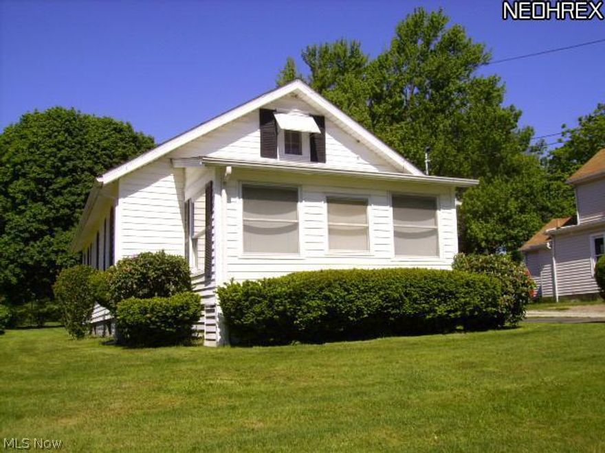 1940 bungalow with nearly one acre treed city lot.  One car garage with opener and attached carport and blacktop drive.  Two bedrooms, possible three.  One bath with tub/shower combo.  All floors carpeted have very nice hard-wood under carpet.  NEW electric service March, 2013.  Irregular lot has 12.5 ft. parcel to Mill Road.  Total lot size is over one city acre.  This is an estate subject to probate.