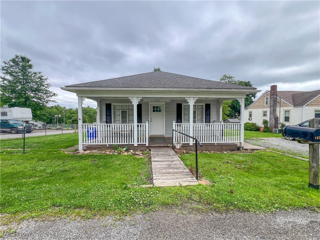 Spacious two-bedroom home with many updates on a double lot. Outside the home, there is a fenced-in side yard, two driveways, a deck in the rear, and a covered front porch. On the main floor, the home features a large living room with a brick fireplace, a dining room with a brick fireplace and built-in cabinetry, two bedrooms, a newly remodeled full bathroom, a brand-new kitchen, a first-floor laundry room, and a sun/morning room. All of the flooring on the main floor is new. Downstairs in the basement, the home has two storage rooms, a storage closet with built-in shelving, and an attached garage.