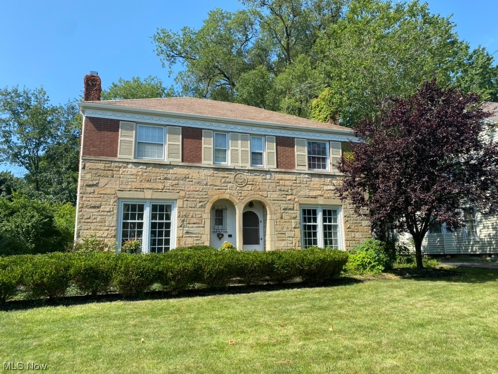 Spacious Brick & Stone Center Hall. Updated & Move-in Ready. Shows Beautifully with Today's Decor. Features Hardwood Floors, Living & Dining Room with Floor to Ceiling Windows. Great First Floor Family Room. Kitchen with Stainless Appliances & Bay-Windowed Eating Area. Four Bedrooms & 2 Full Baths On 2nd Including Master Bedroom Full Bath. Finished Lower Level with Fireplace, Granite Topped Bar & Recessed Lighting. Great Location!