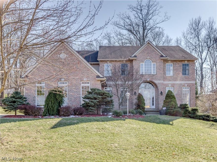 Located in The Woods at Nobles Pond this exquisite brick home is beautifully landscaped & is a must see. Walk through the front door and you are greeted w/ an expansive foyer, open double staircase & soaring ceilings.  Floor to ceiling windows on either side bring in lots of natural light. Hardwood floors & ceramic tile throughout this home have been beautifully cared for. The curved archways are a grand touch in the formal living room & dining room. Moving into the great room you will notice the dual sided gas fireplace, catwalk balcony, open concept into eat in kitchen, and a grand study/office w/ glass pocket doors that are just stunning. First floor full bath is an added bonus to this home. Venture out onto the patio to enjoy the beautiful picturesque back yard w/ mature trees and privacy. The kitchen is a cooks dream w/ lots of cabinetry, pantry, beautiful granite countertops & island. The big mud room w/ built ins also houses the first floor laundry. The second floor master has a