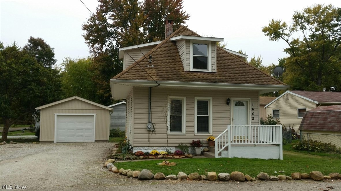 Absolutely amazing Lakemore home with a lake view! Throw a stone to the lake! Completely remodeled inside and out! Siding(10 year), roof and gutter (7 years), windows(10 years), brand new deck, exterior waterproofing, newly painted steps & rail. The garage- 10 year roof, opener, built in shelves, cement floors, locking side door, multiple electrical outlets & fresh paint. Extra large drive to fit all your vehicles & your boat! House walls & attic have additional insulation(10 years). Don't forget this home includes 2 lots! Giving you tons of yard, charming landscaping & huge gorgeous Magnolia tree that the neighbors will envy this spring. Kitchen-new countertops, oak cabinets, brand new floor, new window, newer appliances (elec/gas hook up), new light & newer insulated back door. All new carpet and fresh paint throughout. Dining room has added cabinets & coat closet with additional storage or decorating area above. Banister is made to be easily removed for ease of getting furnitur