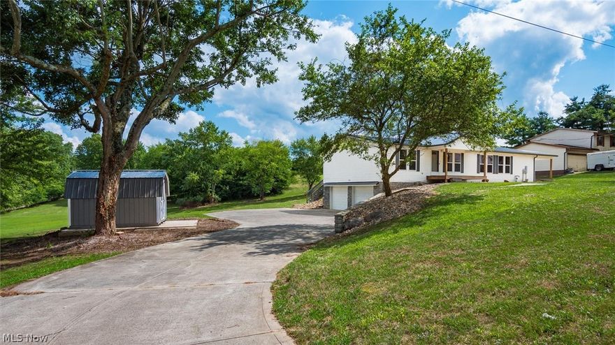 Updated home that is move in ready and waiting for you!  Nice open floor plan, neutral decor. Decorative fireplace highlights the living room opening to huge, multi-level deck. Basement with built-in 2 car garage, excellent for additional storage space, or to finish for additional living area. New roof, furnace, central air, water heater! Beautiful views of the countryside from your back deck. Won't last long!