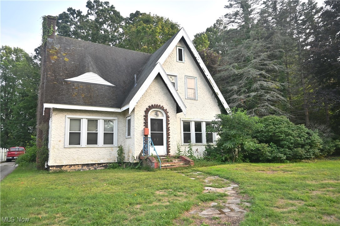 This Tudor Revival home isn’t your average house. Step inside to find hardwood floors, two sets of French doors in the living room, arched doorways, a grand staircase and a few other vintage touches that give it all the character. Upstairs, the full bath still has its original tile — a detail you don’t see every day. Yes, it needs updates. The kitchen, baths, roof, and general repairs are all waiting on someone with vision. But on the bright side, the electrical and heating are already in good shape, and the bones of this house are solid. Set on nearly an acre across three lots, with a private backyard that tiers down the hill, this property is full of space, charm, and potential. All it needs now is someone to love it back to life.