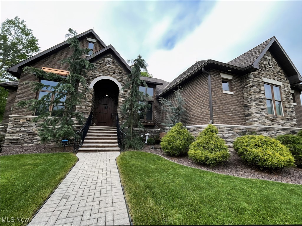 Exquisite Custom-Built European Cottage Estate in an Elite Neighborhood situated on a DOUBLE LOT with additional Guest Quarters. Step into luxury with this breathtaking 5-bedroom, 6-bathroom custom-built home, designed for elegance &comfort. This masterpiece showcases classic French Provincial charm with an exterior of brick and stone, a stunning stone driveway & a heated/cooled 29x22 side-load garage. Inside sophistication abounds with a coffered ceiling in the living room, rich architectural details & gorgeous engineered wood floors throughout. The master suite is a private retreat, featuring French doors a luxurious master bath & water closet, dressing table, double vanity, custom cabinets, walk-in closet with custom wood shelving for beautifully organized storage & heated towel warmer. Offering 2 custom gourmet kitchens, each with custom cabinetry, pot fillers & quartz/granite countertops, making meal preparation effortless. 2 laundry areas on the main floor, full poured basement provides ample storage and includes a sauna for relaxation. Upstairs bonus en-suite with a full bath adds versatility, while the additional Guest Quarters includes 1 bedroom, full kitchen with Quartz countertops, full bath with stackable laundry, Living Room with electric built-in fireplace, private patio & private entrances make this home perfect for multi-generational living or guest quarters. 4-season room, features fireplace, ceramic floors, and a skylight. Modern upgrades include a Generac whole-house generator, a salt-free water softener, an on-demand water heater, and a gutter guard system. A Rain Bird full-lawn irrigation system with a convenience tap—no sewage charge! Enjoy a lush, green yard year-round with minimal effort. 2 HVAC systems with smart Nest thermostat. This exceptional estate is a rare opportunity to own a home that blends European charm with contemporary luxury. Beyond the stunning features of this home, what truly sets it apart is the warm & welcoming community.