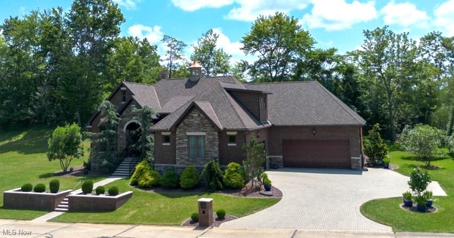 Exquisite European-inspired custom estate on a rare double lot in one of Parkersburg’s most elite neighborhoods, offering 5 bedrooms, 6 baths, and private guest quarters. Designed with French Provincial charm and modern luxury, this home features a brick and stone exterior, stunning stone driveway, and a temperature controlled 29x22 side-load garage. Inside, rich architectural details and coffered ceilings highlight wide plank engineered wood floors throughout. The spa-like owner’s suite is a private retreat with French doors, a luxurious shower, water closet, dressing table, double vanity, custom cabinets, walk-in closet with wood shelving, and a heated towel warmer. Two gourmet kitchens with custom cabinetry, quartz/granite countertops, and pot fillers make entertaining effortless, while two laundry areas add convenience. A full poured basement with ample storage includes a sauna, as well as an upstairs bonus en-suite with a full bath offers versatile living space. Enjoy the 4-season room with fireplace, ceramic floors, and skylight year-round, which can also serve as a beautiful dining space; then step outside to the lush lawn maintained by a Rain Bird irrigation system with no sewage charge on tap use. Modern upgrades include a Generac whole-house generator, salt-free water softener, gutter guard system, on-demand water heater, and dual HVAC with smart Nest thermostats. The private guest quarters feature 1 bedroom, a full kitchen with quartz countertops, full bath with space for stackable laundry, living room with electric built-in fireplace, private patio, and separate entrances — perfect for multi-generational living. This rare Parkersburg estate blends timeless European elegance with contemporary luxury in a warm and welcoming community.