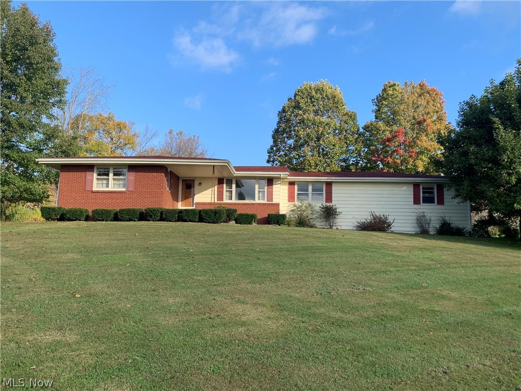 This lovely ranch home evokes classic country style. Perched on a hilltop overlooking the rolling Guernsey County countryside, this spacious 3-bdrm. home features gorgeous, original hardwood floors throughout. Solidly constructed by the original owner in the early 1960s, the home retains much of the timeless charm from that era. Mechanicals (furnace, water heater) are newer and in excellent condition. Attractively landscaped 4-plus-acre lot has mature trees and even a prosperous grape arbor. The single-floor-living home has ample closets and cabinets and a perfect-size kitchen. Wood windows, central air, whole-house fan. Public water and septic system. A little easy and inexpensive cosmetic updating would make this your own cozy home.