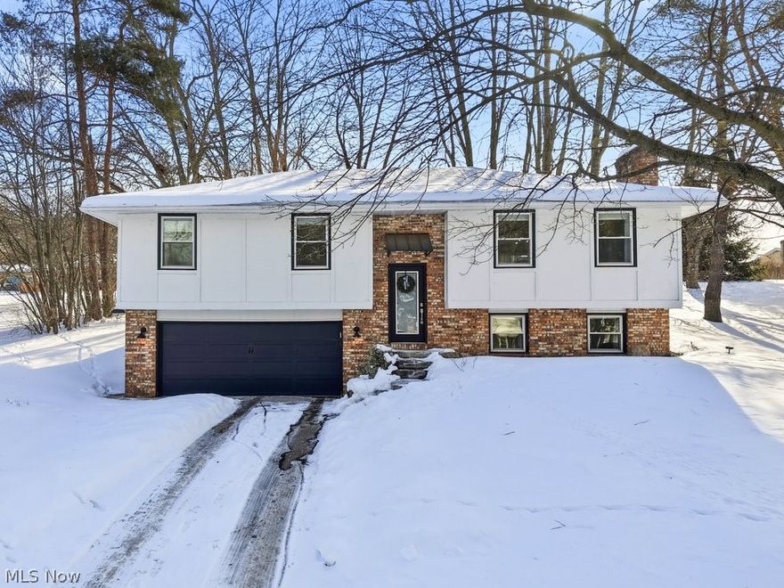 Updated to perfection, this stately bi-level home offers exceptional curb appeal that makes a lasting impression from the moment you arrive. Step inside to an inviting open-concept upper level featuring a spacious living room with ample windows that fill the space with natural light and seamlessly flows into the dining area and beautifully updated kitchen. The kitchen is designed to impress, showcasing a breakfast bar, stainless steel appliances, crisp white cabinetry with statement gold hardware, subway tile backsplash, granite countertops, and recessed lighting. A sliding glass door provides easy access to the deck and backyard—perfect for entertaining or relaxing outdoors. The main level also includes a generous primary suite with a private ensuite bath, along with two additional spacious bedrooms and a second full bathroom. The lower level offers a sprawling second living area complete with a cozy fireplace, half bath, laundry area, and ample storage. Direct access to the attached two-car garage adds everyday convenience to this thoughtfully updated home. Tucked away in a quiet neighborhood with minimal traffic in Perry Schools, this lovely retreat is just waiting for its new owner!