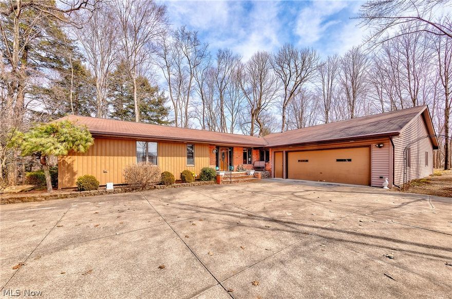 Welcome home! Sprawling two bedroom, three bath Twinsburg ranch has so much to offer. Hudson mailing address in Twinsburg City School District. Your 2+ acre lot of tranquility is tucked away in the trees and has breathtaking views of Tinkers Creek. Step into the foyer and you are welcomed by a warm & cozy living space. Hardwood floors, wood-burning fireplace, and formal dining area. Eat-in kitchen has great countertop space and ample cabinetry with mixer pull out, spice & pan racks etc. The kitchen overlooks both the living space and four seasons room, perfect for interacting with guests while entertaining. Large master suite has its own private deck. The second bedroom is oversized as well. Additional features include an additional living space, office, two car attached garage, detached garage with large overhead door, and more. The additional living space is roughly 960 square feet and has potential for several different uses, depending on your needs. Don’t miss out on the opportunit
