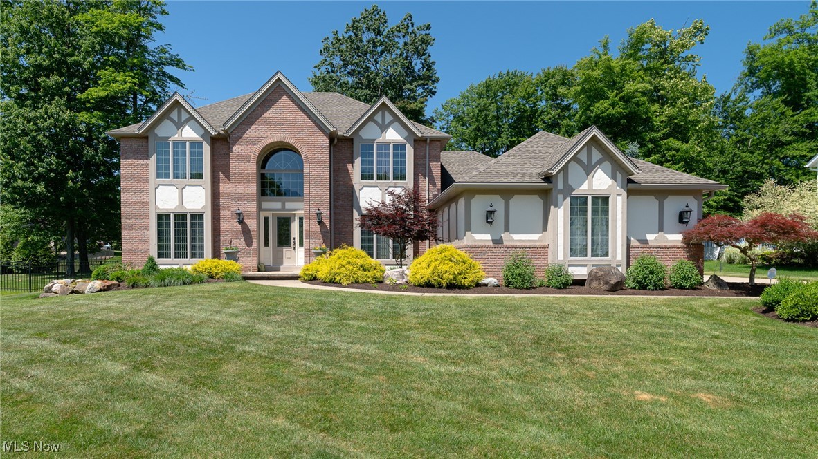 Beautiful 5 bedroom, 3.5 bathroom English Tudor situated in North Royalton. This custom-built home has numerous improvements and upgrades that enhance the beauty of this property. Offering over 3,100 sq ft of thoughtfully designed living space, plus a finished lower level, this home blends comfort, elegance, and functionality. Step into a grand 2-story foyer that sets the tone for the spacious layout. The first floor features a private office and a formal dining room adorned with crown molding, perfect for hosting. The spacious family room offers a wood burning fireplace and a view of the backyard through large windows. The kitchen is the heart of the home, and this kitchen will not disappoint! This kitchen is a chef’s dream, featuring custom Amish built cabinets, quartz countertops, Wolff stovetop, double ovens, microwave, Sub Zero refrigerator, Miele built-in coffee station, and a large island all seamlessly connected to the cozy sunroom. The sunroom comes complete with a wood burning fireplace, wet bar and eating area. Enjoy the convenient 1st floor laundry room. There is a bedroom and full bathroom on the first floor, perfect for a teen suite or a guest suite. On the second floor, you will find the gorgeous Primary suite, complete with a vaulted ceiling, walk-in closet, and a private bathroom. There are three more spacious bedrooms and one additional full bathroom on the second level. The finished basement adds even more value with numerous living spaces: an exercise area, craftroom, family room area, play area, half bath and a storage area. The home has been professionally landscaped complete with irrigation system and custom patio. Backyard features a mineral springs inground heated pool complete with a slide. This home is located within the award winning Brecksville-Broadview Heights School District. Furnace, A/C, H2O tank, Siding, Roofing, Garage Door Openers and Gutters replaced in 2019. Pool Liner was replaced in 2022. Owner is a licensed Realtor.
