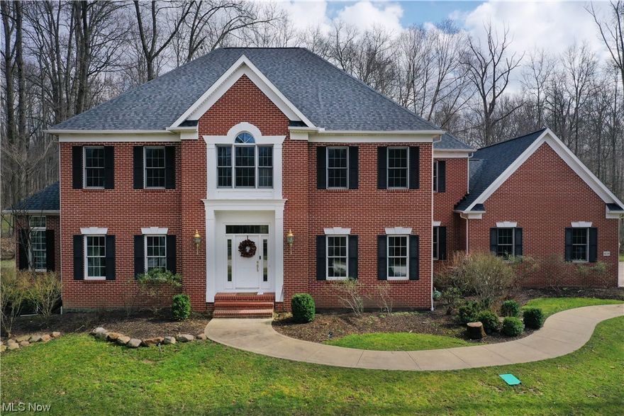 Breath taking custom brick home built by Larry Wojtala on a scenic three-acre wooded lot located in The Ledges that is minutes away from the highway. This one-owner home has been immaculately well kept and offers 5 spacious bedrooms and 4 ½ bathrooms over 4,900 sq feet in above-ground living space with an additional 1,300 square foot finished basement with an eye-catching custom wood bar, full bathroom, and an endless opportunity recreational room. As you enter the front door to an astounding foyer with 10-foot ceilings that lead you to an elegant living and formal dining room with custom-built baseboards and quality crown molding. The sizeable kitchen is in pristine condition and opens up to an attached family room that offers an immense amount of natural light with a full wall of windows and a cozy electric fireplace. Spend all seasons in a classy four-season room that is wonderful for entertaining and connects to the outdoor patio overlooking the magnificent lot that this home sits