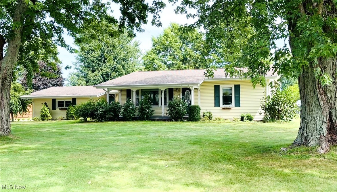 Introducing 18 Lake Breeze Drive - This cutie ranch home offers the ease and convenience of one-floor living with Lake Erie as your neighbor. This home has great curb appeal and offers over 1,300 square feet of space with 2 bedrooms and 1.5 bathrooms. You are welcomed into the bright living room, offering loads of space and charming built-ins. It opens into the large dining room for ease in entertaining and the adjacent kitchen features ample cabinet space with appliances included. There are two bedrooms, each with extra large built-in storage closets. The full bathroom has a shower, vanity with stone countertop and even more storage. Through the front breezeway, you will find a laundry / utility room with a half bathroom. The attached garage features a workshop bench, extra shelving and a storage closet. For even more living space, there is an enclosed back porch with heater and a door to the back yard. The backyard has a small fenced in area, deck and a potting shed. There is .39 acres of land with concrete driveway and space for a boat. The covered front porch is a great place to enjoy the lake breeze! Bring your updates and make this one your own, schedule a private showing today!