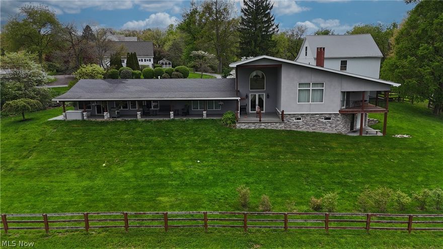 Fully Remodeled Home & Barn situated in Skyview Manor community, connected to the East Liverpool Country Club’s golf course. Located in St Clair Township with no zoning or restrictions! Since its purchase in 2014, the home has been rebuilt with exceptional care and craftsmanship—every exterior wall, window, and door has been replaced. The home is scheduled to receive new shingles in 2026. Inside, you’ll find four bedrooms and three full baths. The showstopping second-floor primary suite offers his-and-her walk-in closets, an ensuite with a soaking tub, oversized walk-in shower, dual vanities, and a picturesque window overlooking the landscape. Step outside to your private covered balcony. A loft-style fourth bedroom completes the upper level. The home is equipped with two gas furnaces, 400-amp electrical service, custom solar shads, and hot-water-heated floors in the basement tile, dining room, kitchen, and family room. The living room showcases a floor-to-ceiling stone fireplace with gas logs, while the kitchen offers a commercial-grade range and a walk-in pantry, ideal for the home chef. The basement provides abundant storage and a full bathroom. Outdoor entertainment is effortless with a large, covered front patio featuring a built-in bar. Equestrian or hobby-farm buyers will appreciate the remarkable bank barn featuring three stalls, multiple lofts, fenced pastures, and a two-car heated garage attached to the barn. The garage sits atop a basement currently utilized as a wood shop, heated with a gas wall unit. An additional 10'x38' outbuilding with electric provides RV or equipment storage. Located just minutes from the Pennsylvania and West Virginia borders, this property offers unmatched convenience while delivering privacy, acreage, and exceptional amenities rarely found in one package. A truly unique offering—luxury living, modern efficiency, and outstanding outbuildings in one of the area’s most gorgeous views. Additional acreage available for purchase.