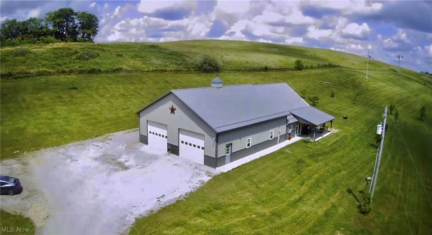 Check out this piece of God's country! This 3 bedroom, 2 bath BARNDAMINIUM was built 4 years ago. Complete open concept of kitchen and living room provides adequate space to entertain.  It features radiant floor heating with 2 seperate heaters so you don't run short of hot water,  blown on metal insulation and an 8 ft oscillating fan in the garage that cools you off.  The property is 50/50 trees and flat usable land.  a cargo unit is equipped with electric hookup to store any needed supplies.  The parking area is already set up for your RV storage.  Complete hookup of electric, water and sewage.  Enjoy your quiet evenings swinging on the front porch. It's breathtaking!!  Contact the agent today to view. Seller is motivated to sell