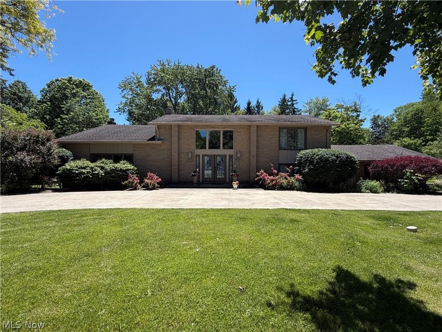 Nestled at the end of a quiet cul-de-sac. This exceptional 5-bedroom, 5-bath home offers luxury, privacy, and resort-style living. A grand circular driveway and impressive curb appeal welcome you into a dramatic foyer with cathedral ceilings, designer tile flooring, and elegant finishes. The main level features a formal dining room with a retractable crystal chandelier, a vaulted living room, and a spacious family room centered around a travertine stone gas fireplace. Custom wood paneling, built-in cabinetry, entertainment centers, and surround sound create the perfect setting for everyday living and entertaining. 
The custom bar area includes quartz countertops, glass bar top, wine storage, refrigerator/freezer, and Scotsman ice maker. The chef’s kitchen is equipped with custom cabinetry, premium JennAir appliances, panel-ready built-in refrigerator, coffee station with pot filler, and a designer island with seating. Custom closets and a spa-inspired bath with vaulted ceilings, skylight, soaking tub, steam shower, and customized walk-in closet. A separate first-floor entrance offers flexibility for guests, a home office, or multigenerational living. The unfinished basemen for  laundry area and storage. Step outside to a private backyard retreat featuring a stamped concrete patio, covered seating area, and fully equipped outdoor kitchen with a Fire Magic Aurora built-in grill, granite countertops, refrigerator, storage drawers, and custom stonework. Enjoy the 16x30 heated fiberglass in-ground pool (2023), hot tub, fire pit, and fenced pool/patio area. Park like setting. Additional highlights include a 2.5-car attached garage, 3-car parking pad, security system, zoned heating and cooling, and numerous custom upgrades throughout.
home combines luxury, comfort, and exceptional indoor-outdoor living in a highly desirable private setting