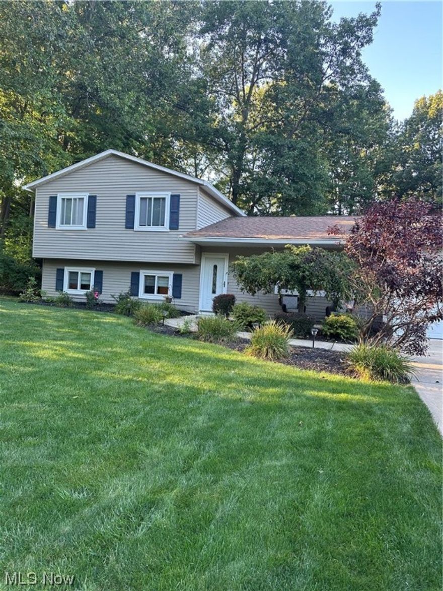 Come and relax! This beautiful split level home has had a complete make over! Kitchen boasts Granite countertops, stylish cabinets, upgraded lights and stainless steel appliances!  Luxury vinyl thru out first floor, family room and both bathrooms. 2 full bathrooms that have been completely renovated.  Gorgeous stack stone fireplace in lower level family room. New furnace and central air in October 2022, New hot water heater. New concrete driveway and front porch.
You will notice the updated doors, windows and trim throughout the home too! Fresh paint and more! Relax in the 3 season room overlooking the Large Deck and private and serene fenced in wooded back yard. Located on a quiet cul-de-sac, close to everything!  2 car attached garage has just had installed new floor coating - Beautiful!