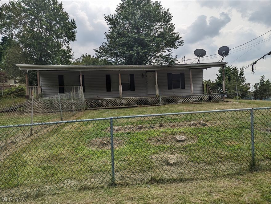 Corner lot modular home in need of a little TLC. There are 3 bedrooms, 2 full bathrooms and a huge front porch all conveniently located near the high school.