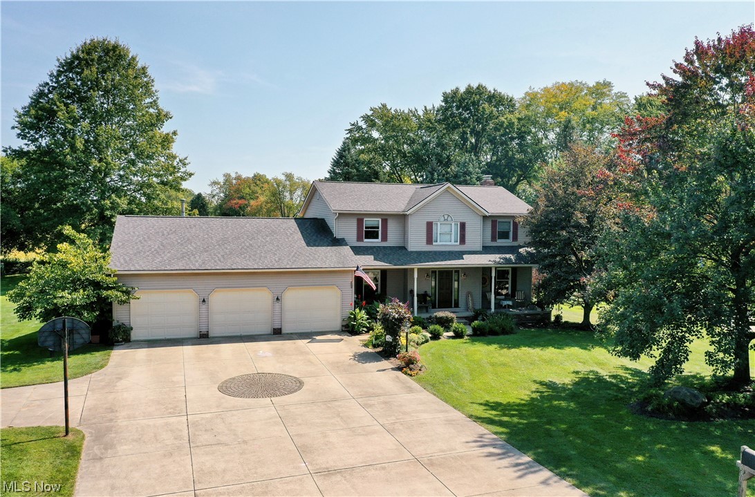 Start your tour of this well maintained and stunningly updated 4 bedroom colonial at the full front porch. Foyer entry through Provia custom front door with stain glass side lights, opens to the formal living room with hardwood floors and the dining room. Armstrong vinyl tile floors from the foyer through the dining room, kitchen, back hallway, 1/2 bathroom and first floor laundry. Custom bayed kitchen features maple cabinets with a cherry finish, center island offering built-in cook top and breakfast bar, built-in wall oven and microwave, farmhouse size stainless steel sink with disposal. The kitchen opens to the dining room and features a custom built wall of cabinets and buffet. All cabinets and cupboards have roll out shelves and soft close drawers. Sunken family room with raised brick hearth gas fireplace. First floor den, first floor laundry, and a 1/2 bathroom complete this first floor living space. Master suite bedroom features catherdral ceiling, an Ikea custom closet system,