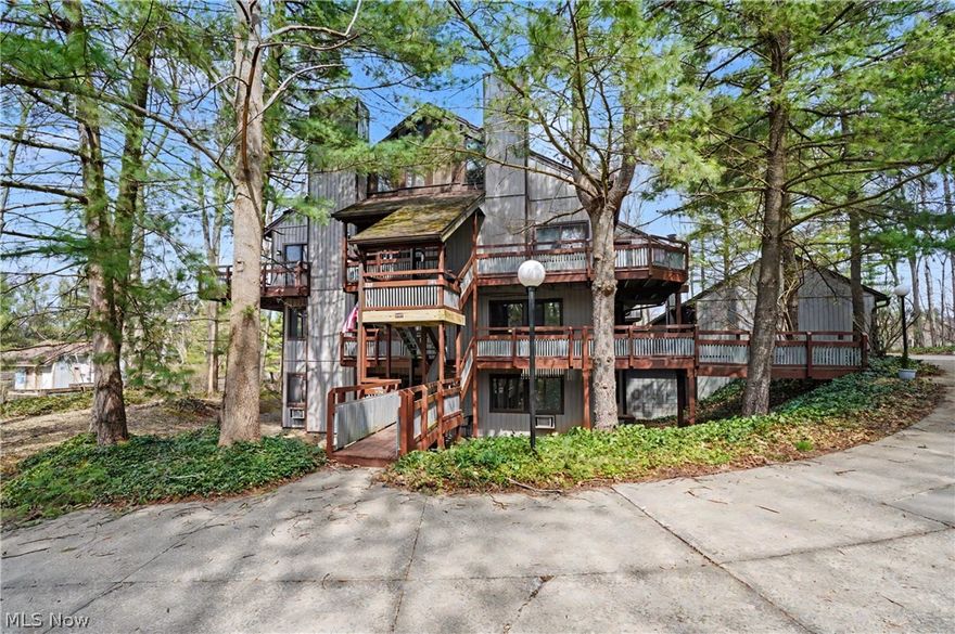 Enjoy the feeling of living in a private community surrounded by beautiful wooded views in every direction. This inviting one-floor condo offers the ease of living.  The spacious living room with gas fireplace is open into the dining area, where an abundance of windows allows for so much natural light. Sliding doors lead to a bright 3-season room — perfect for morning coffee or relaxing at the end of the day — while a second set of sliders opens to a generous deck overlooking the peaceful, natural setting. The kitchen is open to the dining area, offers a pantry and all appliances are included.   The two bedrooms are spacious and offer nice closet space with the bathroom featuring double vanities and a walk-in shower.  The laundry room offers additional storage, and the stackable washer and dryer convey for added convenience. A detached one-car garage is located just a short walk from the entrance, with just a few steps into the front door.  Enjoy access to the two pools this summer and embrace low-maintenance living in a serene, wooded setting.  Monthly fee includes heat, water, trash, snow, landscaping, association insurance, reserve fund and exterior maintenance.