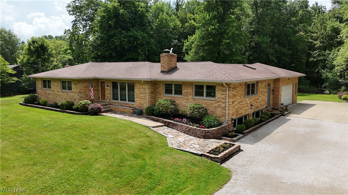 Serenity and peace are waiting for you at 5873 Horning Road! Situated on a large, private lot, this brick ranch home has everything you are looking for. When walking in, you will immediately notice the care and upkeep that this home has, including the detailed woodwork throughout and the quality materials used. The sprawling, open floor plan is ideal for both entertaining and relaxation. As you enter the front door, you are welcome by beautiful wood floors and a large private living room. The formal dining room is conveniently located right next to the updated eat-in kitchen, which has updated cabinets, countertops and flooring. The heart of this home is the unbelievable family room that is centered by a stone fireplace, loads of natural light and dining area! This room is perfect for gathering, celebrating and making memories galore! Three bedrooms are on the main floor, including the primary suite with a newly renovated full bathroom! The other full bathroom on the main floor is completely redone with tile, updated vanity and shower/tub combo. The lower level is a woodworker's dream, with loads of storage and an additional bedroom/office! If this home didn't already have everything you were looking for, wait until you walk outside! The large deck is ideal for entertaining and overlooks the private, wooded lot and well-manicured yard and gardens. Do not miss out on your opportunity to own this beautiful home in the heart of Kent!