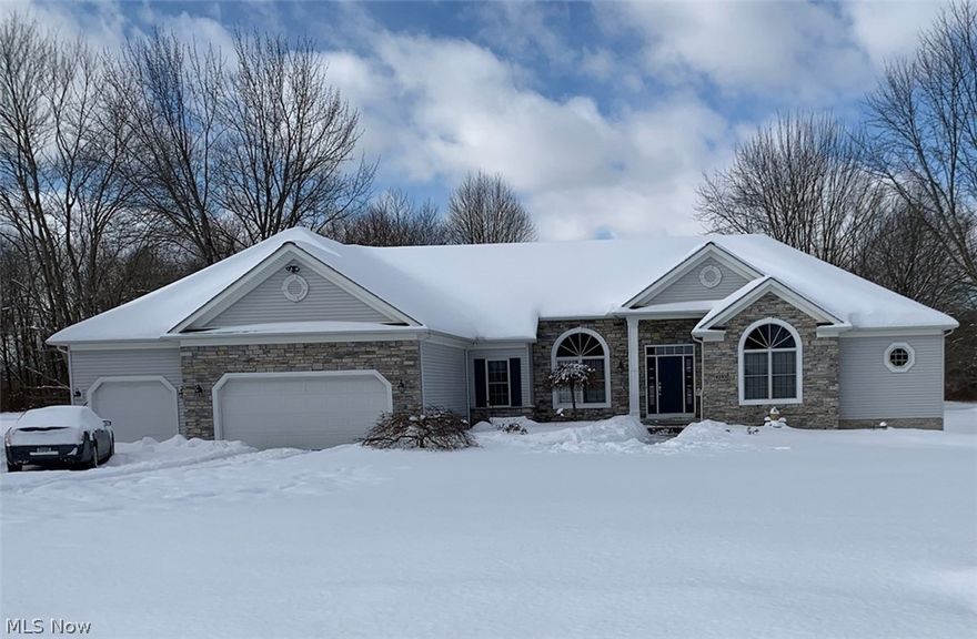 Freedom Township. INLAW SUITE/POTENTIAL RENTAL – If you are looking for a quality custom built home in the Garrettsville School District this is a must see! Perfect for a family looking for independence for in-laws, college kids or rental income. 1000 square foot separate entrance in-law suite is perfectly situated with full kitchen and bath, fireplace and separate bedroom. The basement has a private bedroom, full bath and kitchen for those independent college students or perfect for entertainment/movie/gameroom area. The main house open concept kitchen, breakfast room and living room with fireplace looks out onto a covered patio, deck and beautiful backyard with views of the deer and other wildlife. There is 18 acres of additional property available with 2 out buildings perfect for hunting, for horses and farm animals.