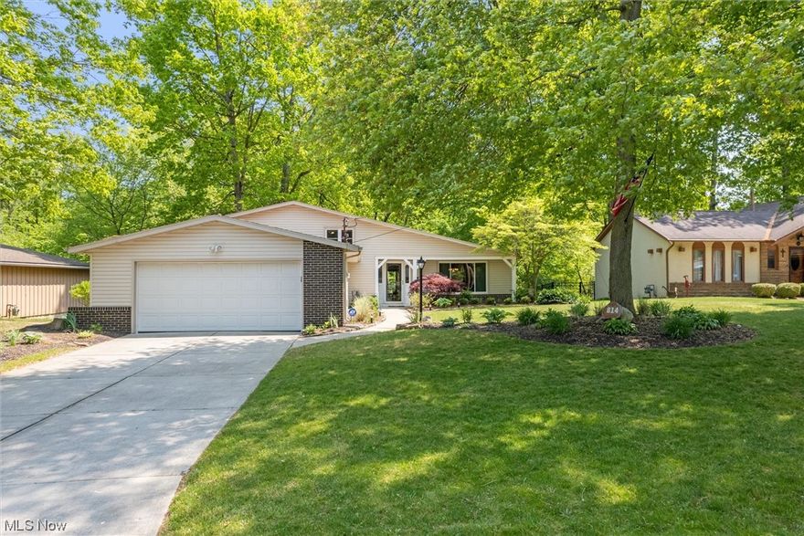 Your dream home awaits! Pride in ownership is evident inside and out. This stunning 3 bedroom, 3 full bathroom split level is nestled on just over a quarter acre, private wooded lot; boasting attractive landscaping and mature trees. Just across the street from Amherst Elementary School and Junior High School. Gorgeous foyer features vaulted ceilings and exposed wood beams. Abundance of natural light throughout. Off the foyer is the spacious sunken living room with newer carpeting. Formal dining room is adjacent to the living room and opens to the kitchen. Kitchen features quality oak cabinetry, quartz countertops, tiled backsplash and coffee/breakfast bar. Off the kitchen is a beautiful sliding door that leads to the expansive, breathtaking 18x24 trex composite deck overlooking the picturesque backyard backing to the creek and woods. Duals as a tranquil place to relax & unwind and a great outdoor entertaining space! Upstairs hosts a remodeled hall bath and 3 ample bedrooms including th