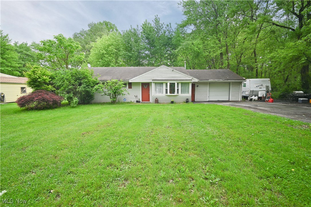 Motivated Seller who has created a new price point that will be hard to pass up! Tucked away on a private 3-bedroom 1-bath ranch on a wooded 1/3 acre lot in Howland School District. Privacy and convenience—just minutes from Eastwood Mall, shopping, restaurants, and major highways, you would never realize it when you pull into the driveway. The spacious layout includes an oversized kitchen with generous cabinet and counter space, a bright dinette, and an oversized living room. The attached garage serves multiple functions with laundry, utilities, and bonus living space. Enjoy the fenced backyard, patio, and mature trees—perfect for outdoor relaxation. With strong bones and a functional layout, this home is ready for you to make the finishing touches. Some TLC is needed, Bring a paint brush, and budget for Roof and HVAC. They are near end of life and A/C is not working. Owner priced in accordance. Whether you're an investor seeking value upside or a buyer ready to customize, this is a great opportunity in a very versatile location. While currently tenant-occupied on a month-to-month tenancy. Seller is willing to deliver the property vacant with 30 days notice prior to closing. Property is located in a flood zone—buyers to verify insurance requirements.Yes, this home is Being sold As-is.