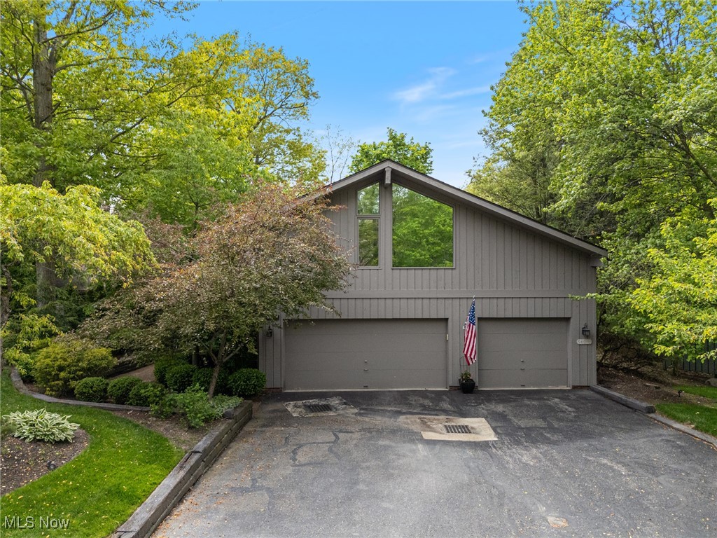 The Walden Lifestyle is calling. Here is your opportunity to own an entertainers dream home nestled among the trees in one of NE Ohio's premier golf and leisure communities. Morning coffee with the birds or an evening with friends around the natural gas fire pit are enhanced by the sheer beauty of nature that surrounds the expansive wrap around multilevel deck with lawn and ravine views providing over 2400 sq ft of outdoor living spaces throughout. Enjoy the ease of gracious single floor living with the added benefit of 2 additional living/sleeping areas for guests or family. The main floor living/dining room is open, airy and quite light filled despite the tree canopy and so cozy with the gas/ wb fireplace and wet bar. A cheerful kitchen is a chef's delight with updated appliances, cabinets galore, walk-in pantry, solid surface counters, a casual eating area with patio sliders to an outdoor dining patio with retractable awning and a 2 natural gas hook ups for your bbq and smoker. The master suite provides ample space for a private sitting/tv area, direct access to the deck, a sumptuous updated bath with soaking tub, walk-in shower and double walk-in closets. The 2nd br or home office with ensuite ba has built-in shelves and private patio. An updated guest 1/2 bath, laundry room and 3-car garage finish this level. The loft, which overlooks the kitchen, offers another sitting/tv/library area, 3rd br with ensuite bath and 2 incredible walk-in storage rooms. The finished lower level provides wet bar, family room WB/G fireplace, the 4th br/full bath. Multiple sliders out to a patio and lawn. Gorgeous flowering perennial trees/shrubs/plants adorn the property. The Walden Lifestyle includes a wonderful list of services like lawn/landscape maintenance and gutter cleaning included in your HOA fees. A tremendous list of big ticket updates is available. Join Club Walden at an additional cost. Membership optional but required to access amenities. Schedule your tour today.