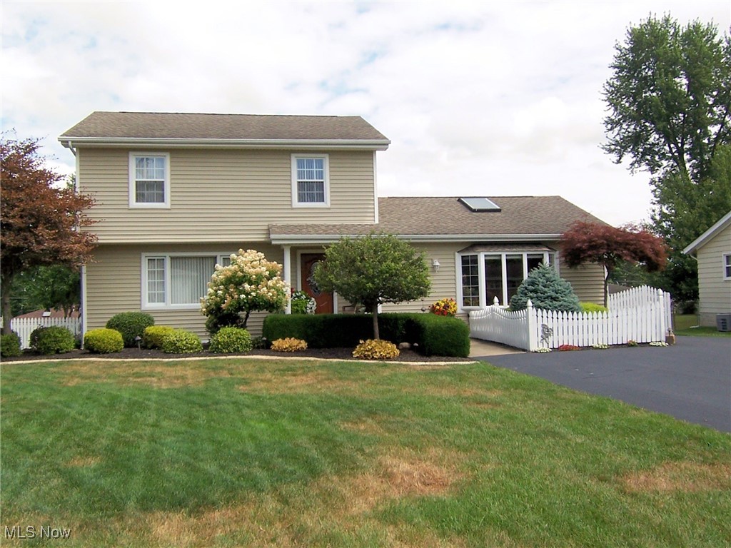 This exceptional,well maintained, super clean one owner home invites you into a comfortable lifestyle for all seasons. Spacious greatroom with bay window leads to covered patio and freshly painted deck to enjoy all summer. Updated kitchen with all newer appliances. Dining area with extra built in cabinets. Living room and half bath complete the first floor of this beautiful home that features hardwood floors throughout. 3 bedrooms and 1 bath on second floor. Partially finished basement with washer and dryer included. 2 1/2 car garage with room for workshop. The landscaping and flower gardens are beyond perfection. A new driveway in 2024. Furnace and fridge 2019. Baseboard heater in great room 2021. Hallway and kitchen floor 2022. Too many updates to list. All mounted TVs stay. Security system