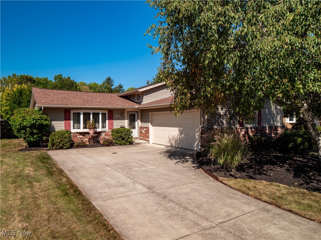 Situated on ½ acre, this well-cared for split-level home offers major updates and over 1900 sq ft of living space with 3 bedrooms, 1.5 bathrooms. Conveniently located near shopping, dining, parks, and highway access, this home makes everyday living and commuting a breeze. Inside, the main level features a spacious living room with vaulted ceilings that flows easily into the dining room. Off of the dining room, a large office addition has French doors and overlooks the sprawling backyard making it perfect for working from home or as a versatile flex space. The eat-in kitchen boasts granite countertops, ample cabinetry, and opens into a sitting room . Enjoy even more space inside the sitting room or step outside to the sprawling Trex deck, ideal for entertaining. Back inside, the lower level offers a cozy family room with a wood-burning fireplace, a half bath, utility room, and direct access to the attached two-car garage. Upstairs, there are three comfortable bedrooms and a full bath. Hardwood floors and newer carpeting are found throughout the home, adding to its move-in-ready appeal. Outdoors, enjoy the beautifully maintained landscaping, a peaceful waterfall feature, newer storage shed, and plenty of deck space to relax or host gatherings. With major updates already completed like a new furnace and AC in 2024, new hot water tank in 2023, and new roof with gutter guards, this property blends comfort, functionality, and charm in one of Parma’s most convenient locations. Come see today!