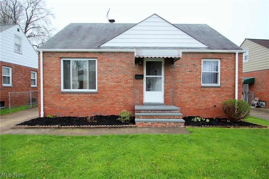 Brick 1-1/2 story home with fenced yard, full basement and a 2 car garage. This home features beautiful hardwood floors throughout the first floor. Eat-in kitchen with wood cabinets and newer counters and flooring. Full finished basement with recreation room, possible bedroom or office and full bath. Large upstairs dormer with extra built in storage and living area. Updated bath on main floor with ceramic tile, vinyl windows and Seller is offering a 1 year warranty with America Preferred