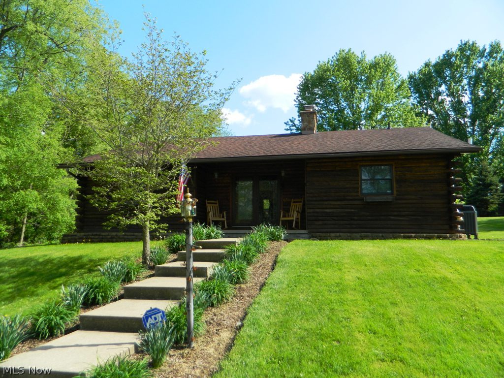 Four bedroom ranch log home located on 9 acres. Scenic wooded views are yours in this park like setting. A newly remodeled kitchen, newer windows, new heat pump and central A/C, 2 + car detached garage, 30x20 barn with electric, and an additional kitchen and bedroom in the lower level are all amenities offered in the home.