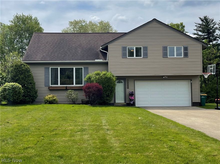 Move in ready doesn't get any better than this spacious split level in a charming neighborhood that's close to schools and shopping.  This open, updated kitchen has no shortage of cabinet space as well as a lovely and light 4 seasons room right off the eat-in kitchen.  You will love all the hard wood floors and modern paint colors to complement  the generously sized bedrooms as well as lower level living space that walks out to the back yard where you will enjoy the large fenced in yard and covered back patio.  New roof and siding (2015), garage door and opener (2018), Sliding glass door (2021), microwave (2019), dishwasher (2021) Trust me you won't want to miss this one!