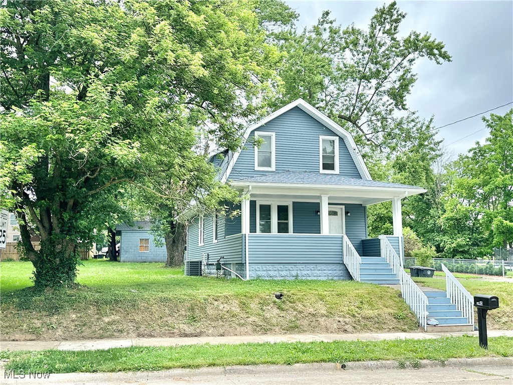 Charming and updated two-bedroom, two-bath Cape with a spacious two-car garage. Enjoy relaxing on the large front porch or entertaining in the modern kitchen featuring a breakfast bar, updated cabinets and appliances. Both bathrooms have been tastefully renovated. Convenient first-floor laundry adds ease to everyday living. The property includes three parcels, with potential to build on two—ideal for future development or expansion. Move-in ready and full of possibilities! Updates in 2024 include Vinyl Siding, Roof, Furnace and AC, Water Heater, Windows, Gutters & Downspouts