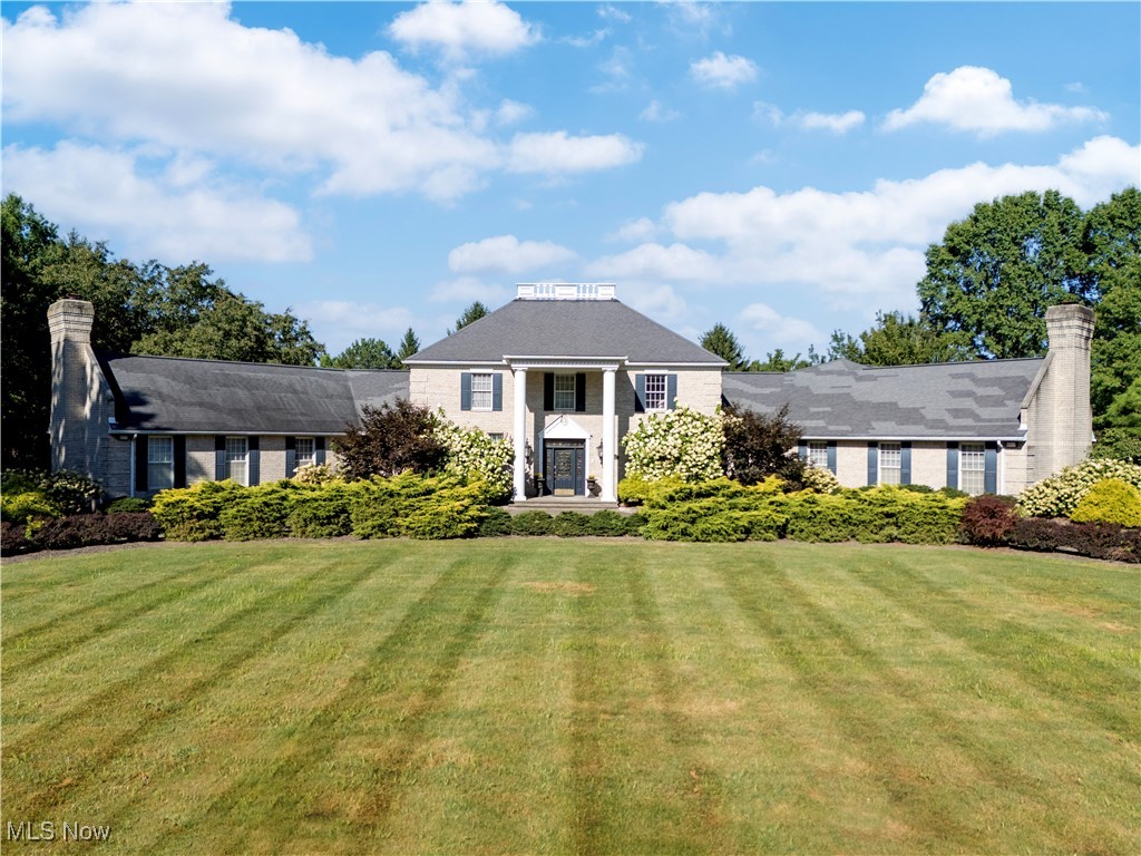Welcome to this remarkable Colonial style residence offering 6149 sq ft of living space with an additional 4721 sq ft in the basement. Set on 4 city lots (over 2 acres). This estate combines timeless architecture with luxurious amenities for both everyday living and entertaining. As you enter the house you will be welcomed with a 2 story foyer open to formal living with a fireplace and dining room. Inside you will find 4 spacious bedrooms, 4 full baths and one 1/2 bath. The primary suite retreat features fireplace, his and her closets, a spacious bath with a sauna and weight room . Upstairs you will find three additional bedrooms and two full bathrooms. The home's thoughtful design includes expansive living and dining areas. The first floor laundry and mudroom off the 4 car garage add convenience, while the garage also offers direct stair access to the massive basement. Enjoy the outdoors under your gazebo, at the patio or playing a round of tennis on your private court. The gated entry to the garage and the circular front driveway create a grand first impression making this property truly one-of-a-kind. If you are a car enthusiast the 4 bay oversized garage you will appreciate. With its grand scale, functional layout, and luxury features, this estate offers the perfect balance of comfort and sophistication.