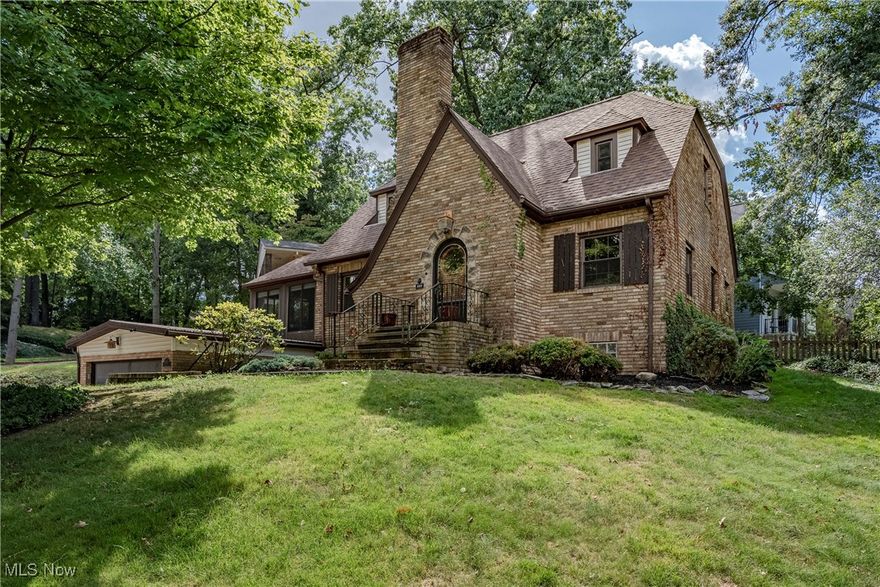 Welcome to 453 Palisades Dr – Timeless Charm in Merriman Hills!

This all-brick Cape Cod combines classic character with thoughtful updates, set on a picturesque corner lot in one of Akron’s most desirable historic neighborhoods. With 3 bedrooms, 1.5 baths, and a warm, inviting layout, this home is perfect for both everyday living and entertaining.

Step inside through the custom arched door with leaded glass into a welcoming foyer that flows into the spacious living room, anchored by an elegant fireplace. Just off the living room, a light-filled sunroom with vaulted ceilings and three walls of windows creates the perfect year-round retreat. The formal dining room showcases hardwood floors and rich millwork, making it ideal for gatherings.

The kitchen blends charm and function with stainless steel appliances, tile flooring and backsplash, ample cabinetry, and a cozy eat-in nook. A first-floor bedroom with hardwood flooring and wood paneling, plus a convenient half bath, complete the main level. Upstairs, you’ll find two generously sized bedrooms with hardwood floors, along with an updated full bath.

The lower level extends your living space with a finished rec room featuring a fireplace, a bonus office or hobby room, laundry area, and plenty of storage. Outside, enjoy a fenced-in backyard with a newer patio—perfect for relaxing or entertaining. The oversized garage offers two-car width with room to accommodate a third vehicle.

With original details like doorknobs and millwork paired with modern comforts, this Merriman Hills gem offers the best of both worlds. Don’t miss the opportunity to make this beautiful home yours!