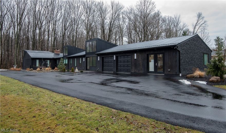 Exquisite contemporary  ranch on a 1 acre wooded parcel in South Russell. Geauga taxes/Chagrin Falls Schools.  Although it says year built 1959, this home is a 1000% total remodel  from the ground up.  Everything has been replaced and is STUNNING through-out.  Wide open floor plan with high ceilings and lots of natural light shines through all new Pella windows.  Enjoy a glass of wine while relaxing at the seated area in front of one of two fireplaces.
  High quality Commercial grade laminate flooring ,New Carpet in all 3 bedrooms and living room. All Brand new wiring and fixtures with all LED lighting. The 3 baths completely gutted and redesigned.  Freshly painted through out .  Gorgeous new kitchen with classic white shaker cabinets/granite counter-tops/ All Stainless appliances including built in wine cooler and water fridge. Re -purposed industrial wood cabinet with mini drawers in kitchen. Custom built wall wine rack in dining room. So many fascinating features and stunning decor