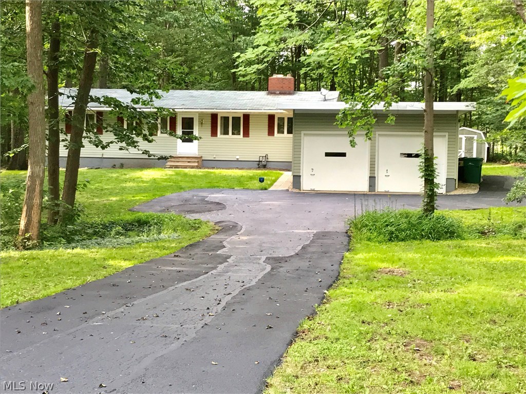 Spacious Ranch set back on wooded cul-de-sac lot. Open Dining room flows into large great room with wood burning fireplace and a wall of windows overlooking the private wooded views of the backyard. Mature trees and songbirds make this feel like a retreat. New carpet installed in all bedrooms and great room (hardwood underneath). The basement rec room is half finished which leads to outside, making it a walk-out basement. Some updates from the last 4 years include: City Water conversion, electric, recessed lighting, driveway, bath tub surround, carpet, refrigerator, microwave, washer and dryer. This is a great house in a great neighborhood, and even comes with a one year warranty!! Call for your private showing.