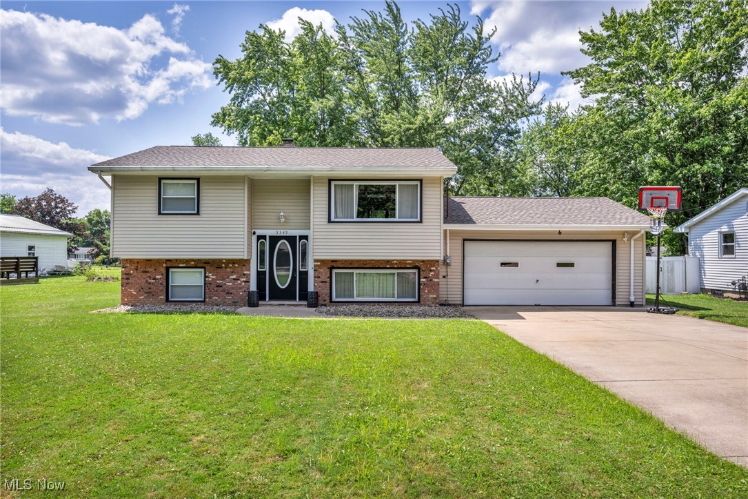 Welcome to this beautifully remodeled bi-level home in the desirable Champion School District! This move-in ready property offers spacious and stylish living across both levels. The lower level features a generous living area, two bedrooms with egress windows, a convenient half bath, and a laundry room—all with direct access to the attached two-car garage. Upstairs, you'll find a bright and open living room that flows into the updated kitchen, complete with quartz countertops, subway tile backsplash, and modern finishes. Two additional large bedrooms and a full bath complete the upper level. Off the dining space, a sliding glass door opens to a two-tiered deck overlooking the expansive, fully fenced backyard and concrete patio—perfect for entertaining or relaxing outdoors. With updates throughout and nothing left to do, this home is truly move-in ready!
