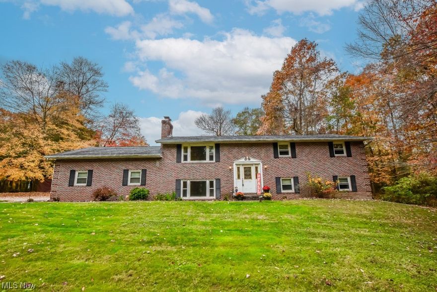 Nestled among 14 serene wooded acres, this stately brick bi-level home offers a comfortable and private retreat and includes FREE GAS! The main level welcomes you with a warm living room, complete with a fireplace and gleaming hardwood floors. Moving seamlessly from the living room, you'll discover an updated kitchen featuring granite countertops, a practical breakfast bar, and a dining area with access to the deck. The three inviting bedrooms down the hall are accompanied by two full baths. The master bedroom, with its private access to the deck, boasts an en suite bathroom with double sinks while the secondary bedrooms share an updated bathroom from the hall. Venturing to the lower level, a cozy family room awaits, complete with a wood stove and a game room perfect for entertaining. A bonus room on this level serves as an ideal home office, and a convenient half bath completes the space. The lower level also offers direct access to the two-car attached garage while the detached garage adds extra space for parking and storage. Outside, you'll absolutely love the amenities of the above-ground pool, and the gazebo-covered deck, which features a relaxing hot tub plus the potential for horses and 5 tillable acres. Recent updates include a newer water softener, well, and septic distribution box. This is a rare find you don't want to miss, call today!