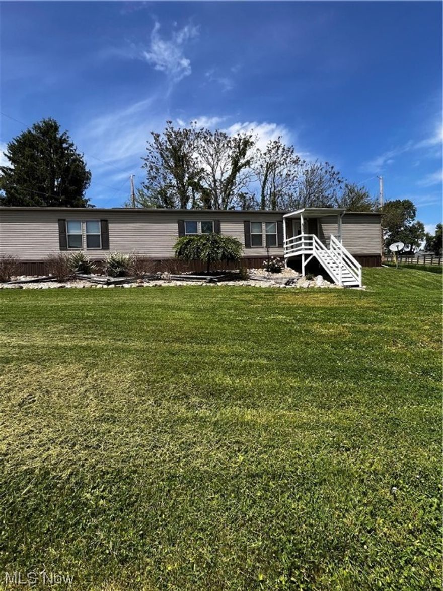 Check out this newer mobile home on a gorgeous, rented lot. This home features: 2 bedrooms and 2 full bathrooms, eat in kitchen with beautiful cabinets and granite countertops, carport, and, screened in covered back porch with a view of the countryside. Sellers recently had the storms doors added, solar lighting, landscaping, and decks painted. Water, sewer, and trash is $107 a month, per the sellers. Home is on a rented lot. Lot rent is $ 225 a month. Home will come partially furnished. List of included furniture will be provided.