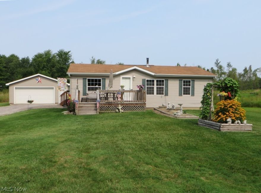 Absolutely adorable and well maintained manufactured ranch home on cement crawl. Home is real estate. This ranch is situated on a 2.44 acre corner, treed lot. Yard is full of perennials and nicely landscaped. 24x24 garage with electric and opener, plus nice storage shed with electric. Home also has wood burning stove for supplemental heat source. This is a "move in" and enjoy home.